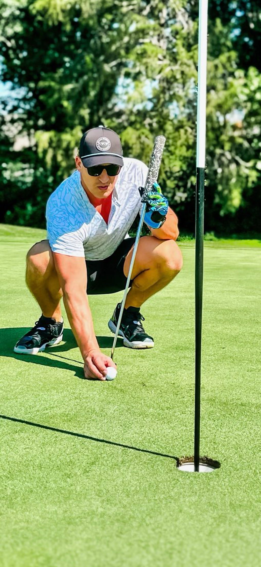 lightweight golf hat with black and blue logo and rope