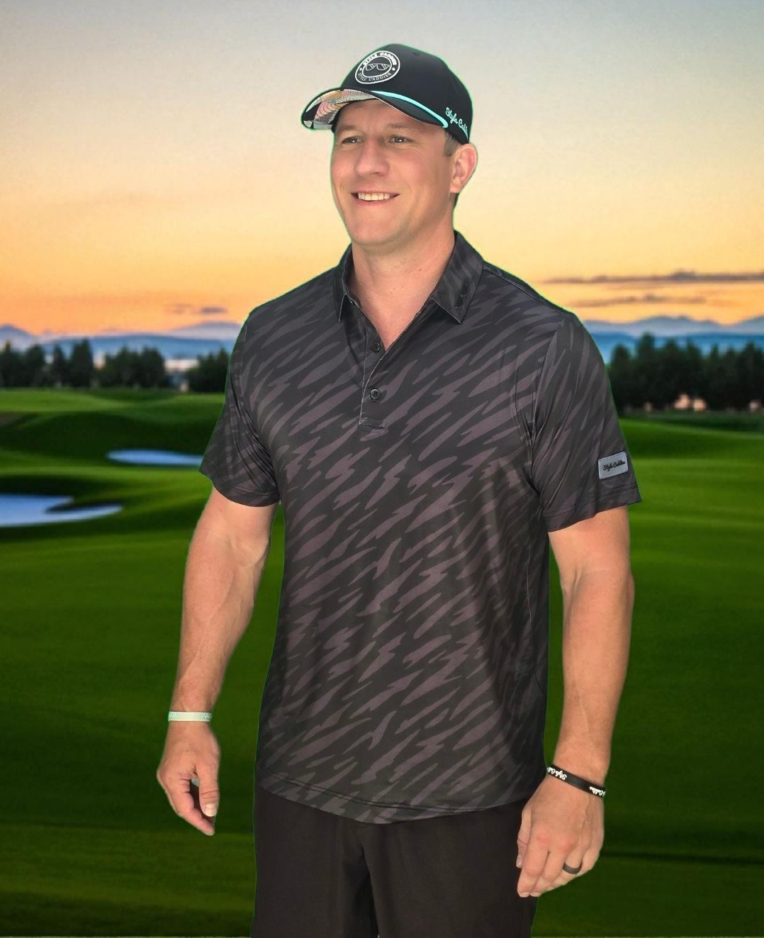 Man in striped golf polo standing on a golf course with a sunset background