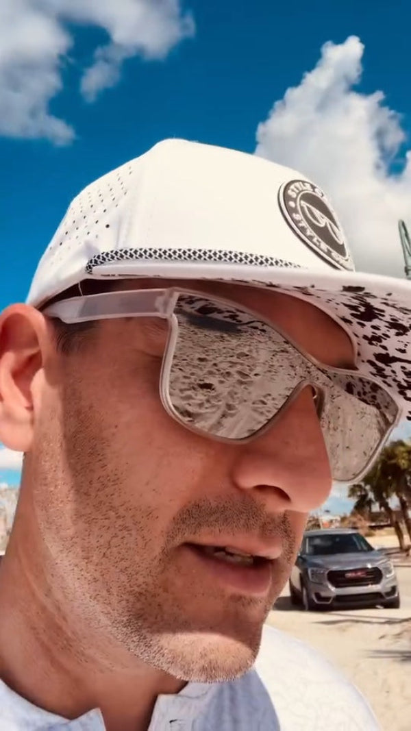 man wearing white golf hat with splatter under