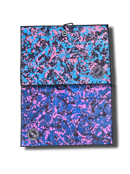 Two splatter-patterned magnetic golf towel with a brand logo