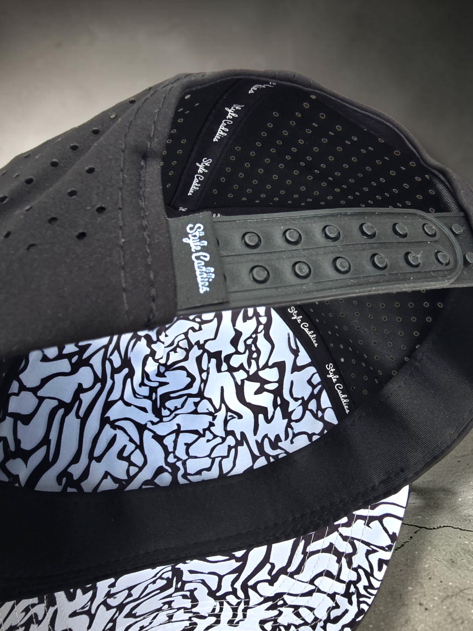 Close-up of a hand holding the interior brim of a Style Caddies hat