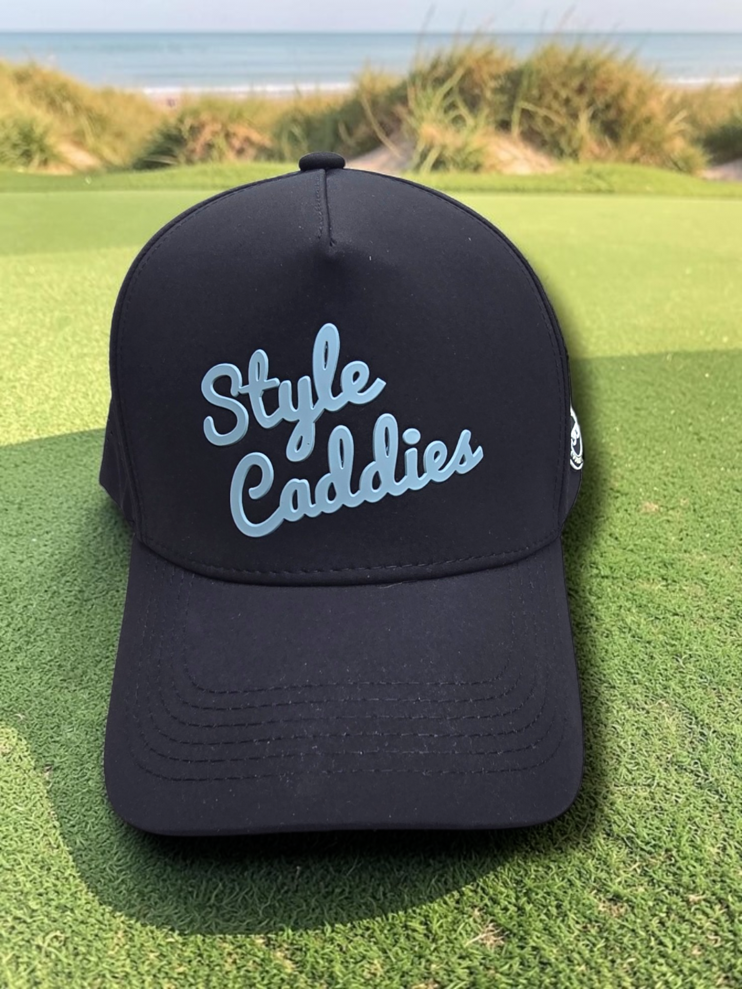Black Style Caddies hat interior underside detail showing the splatter print lining
