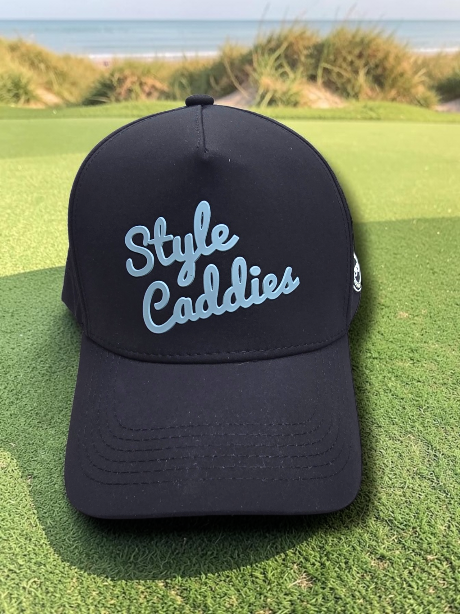 Black Style Caddies hat interior underside detail showing the splatter print lining