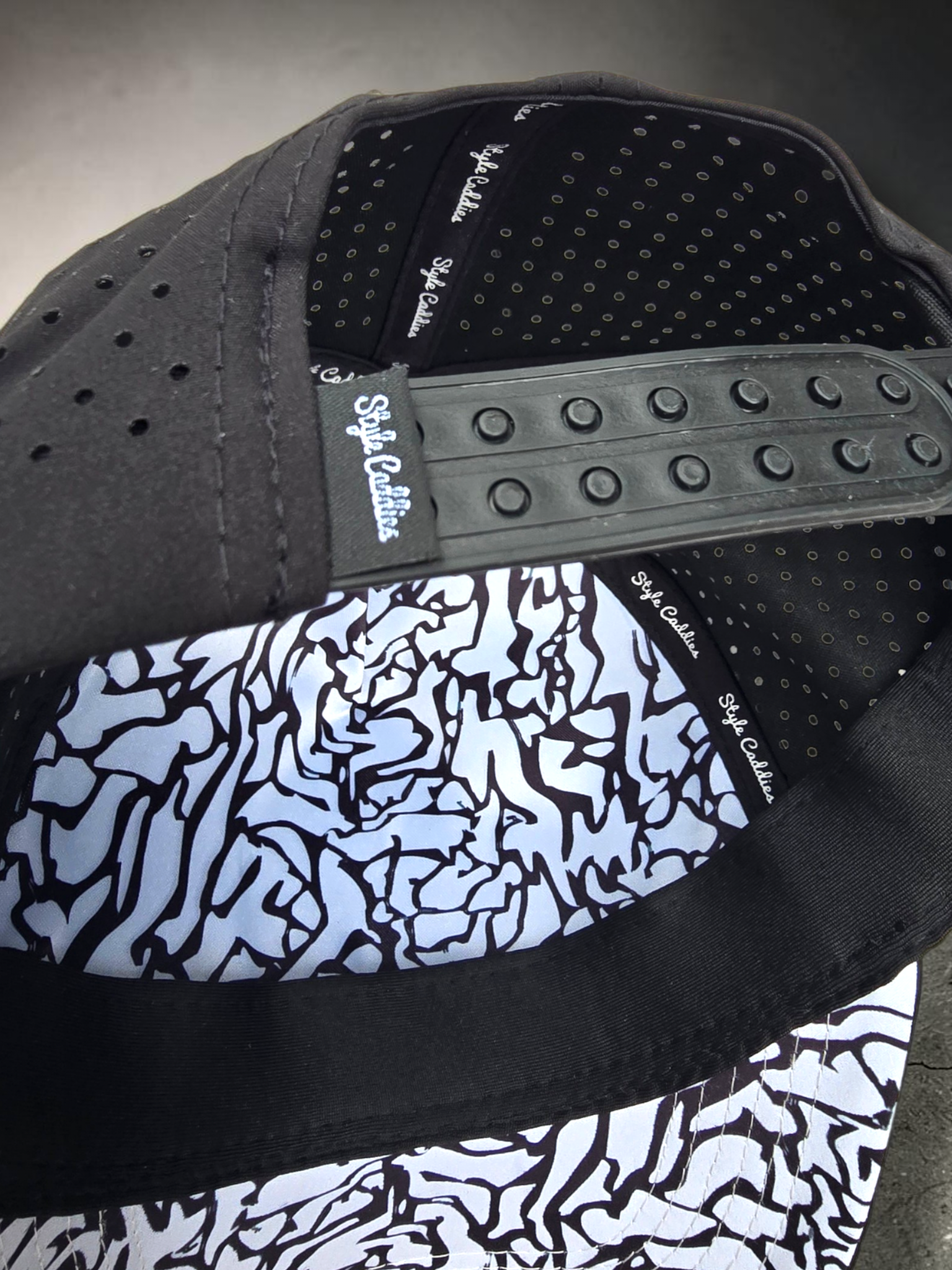 Black Style Caddies hat worn outdoors on a city plaza boardwalk