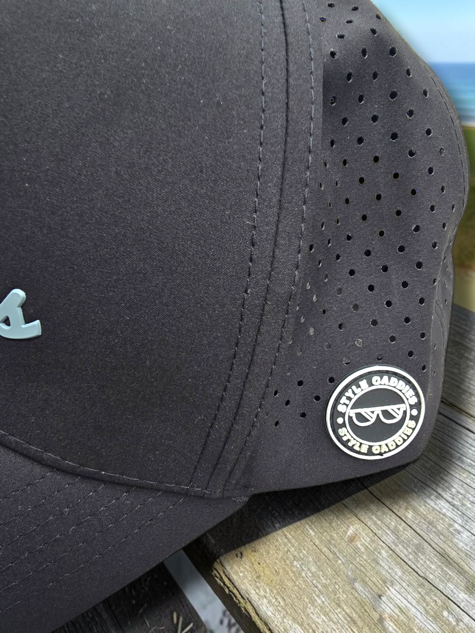 Two Style Caddies hats, black and navy, shown underside-up together outdoors