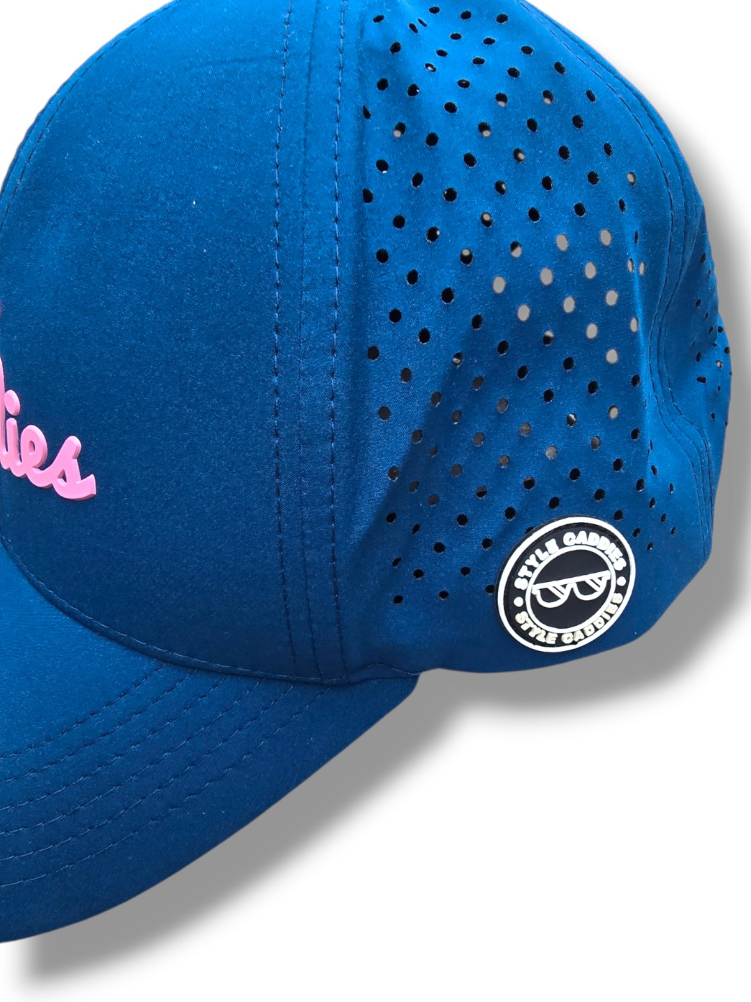 Close-up of a hand holding the interior brim of the navy Style Caddies hat
