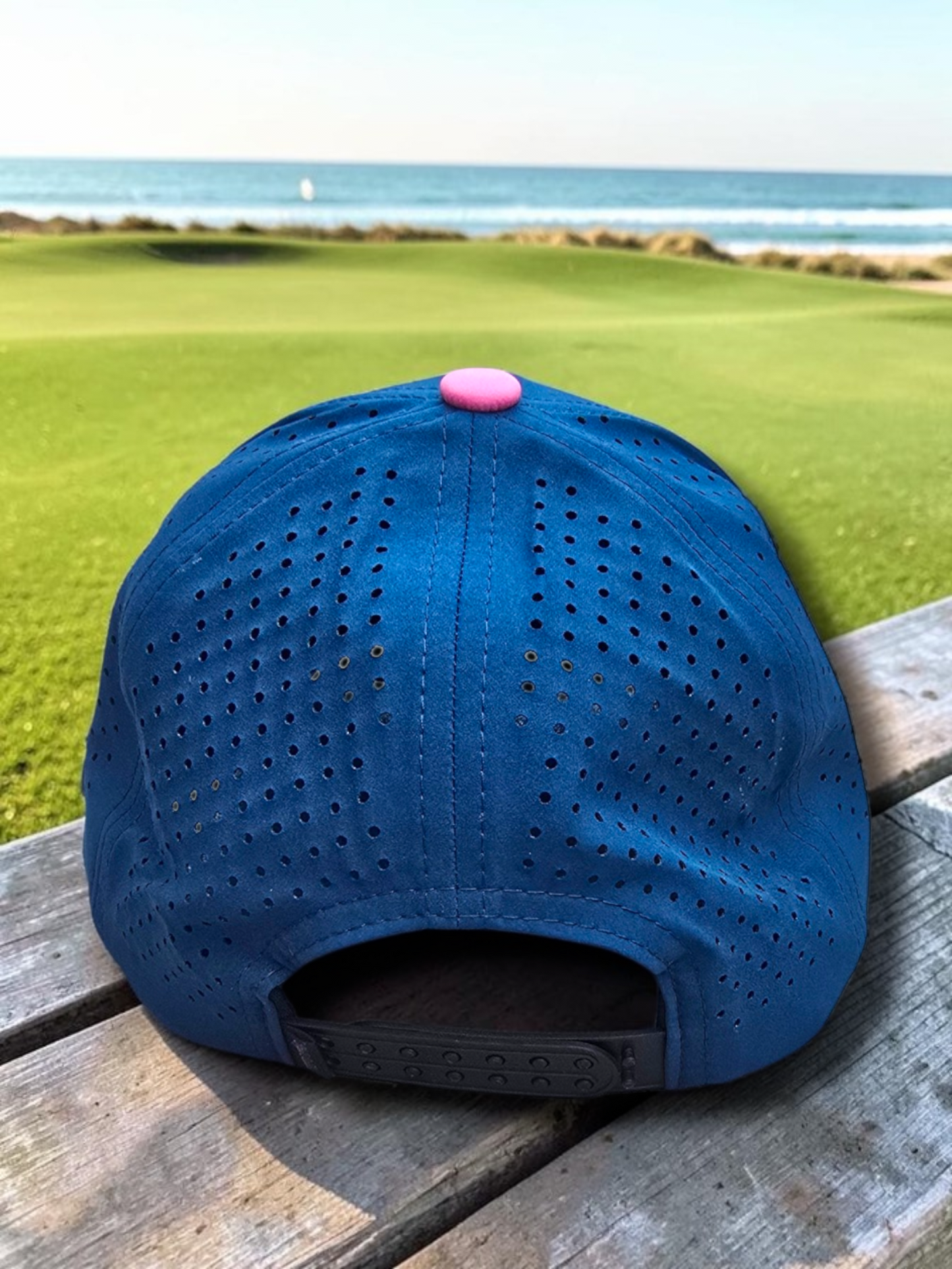 Navy Style Caddies hat underside view showing pink and black splatter print and perforated crown lining