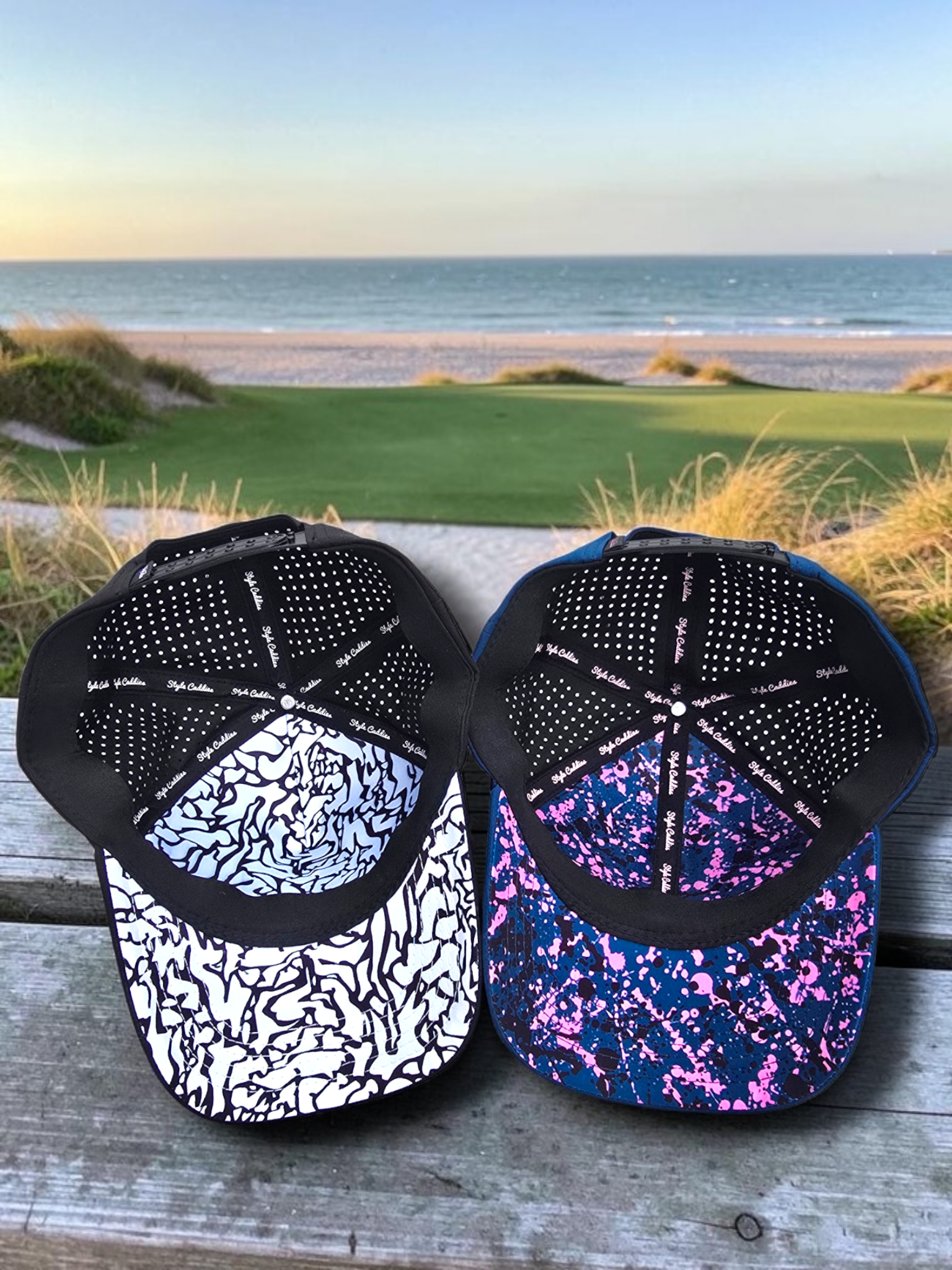Two Style Caddies hats, black and navy, shown underside-up on a golf course boardwalk