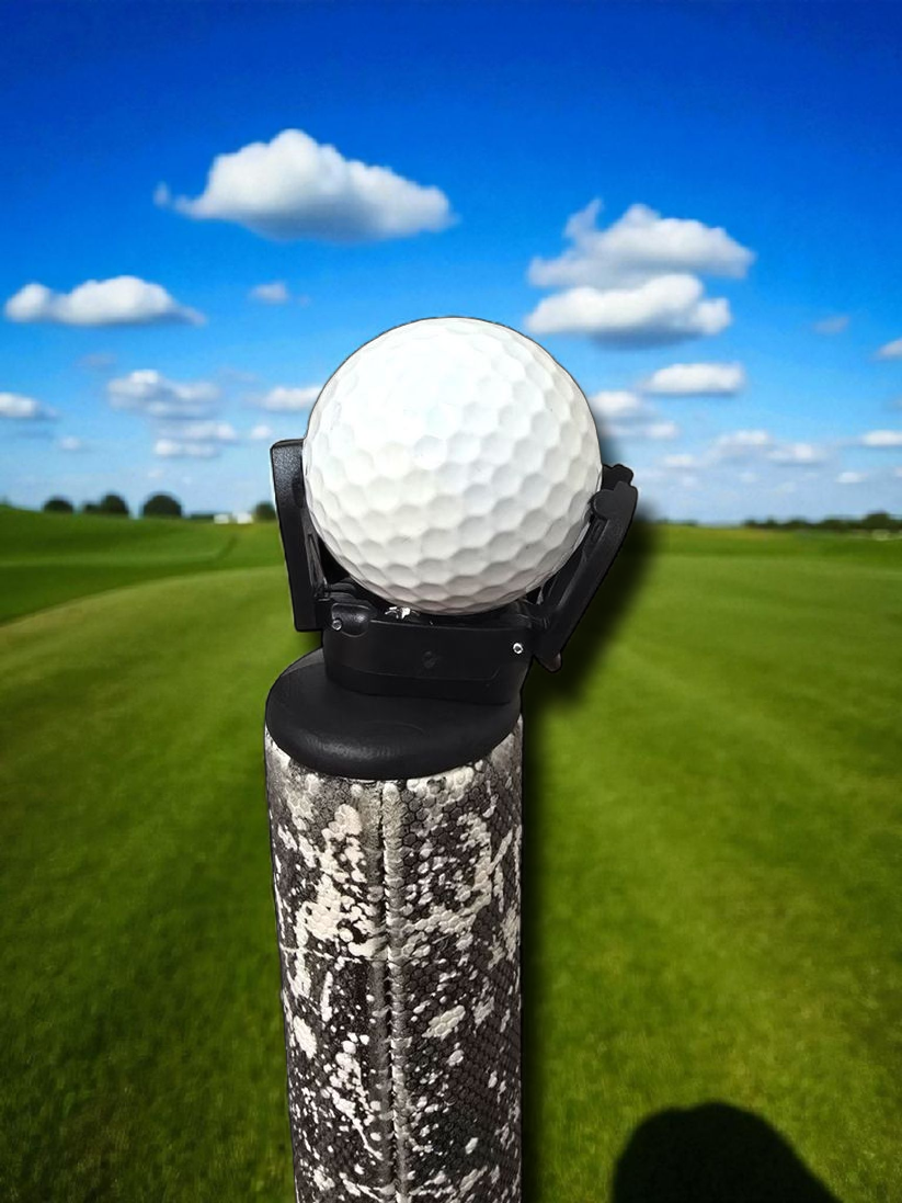 Golf ball grabber installed on putter in use on course