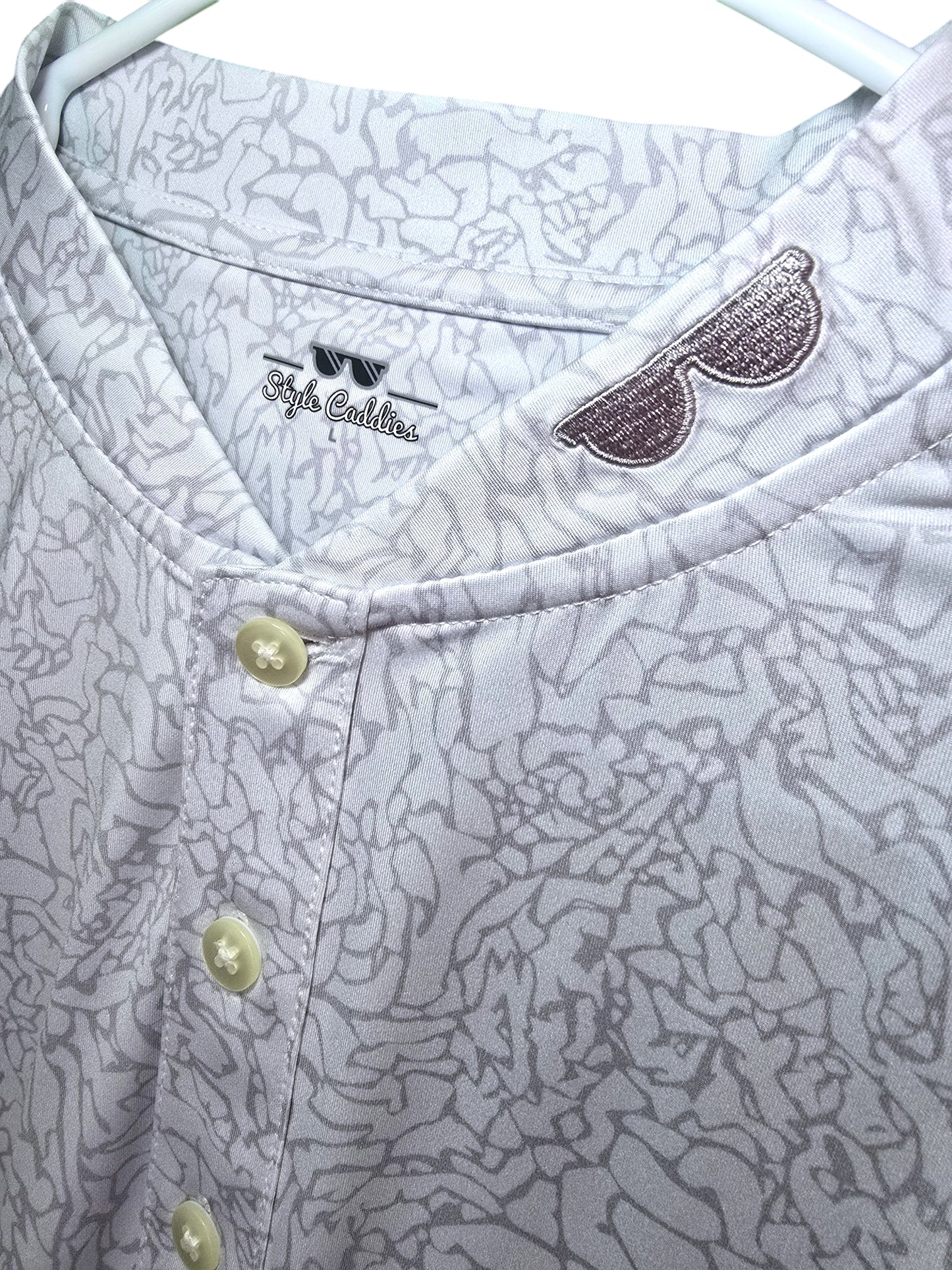 Light cement collarless golf shirt on course
