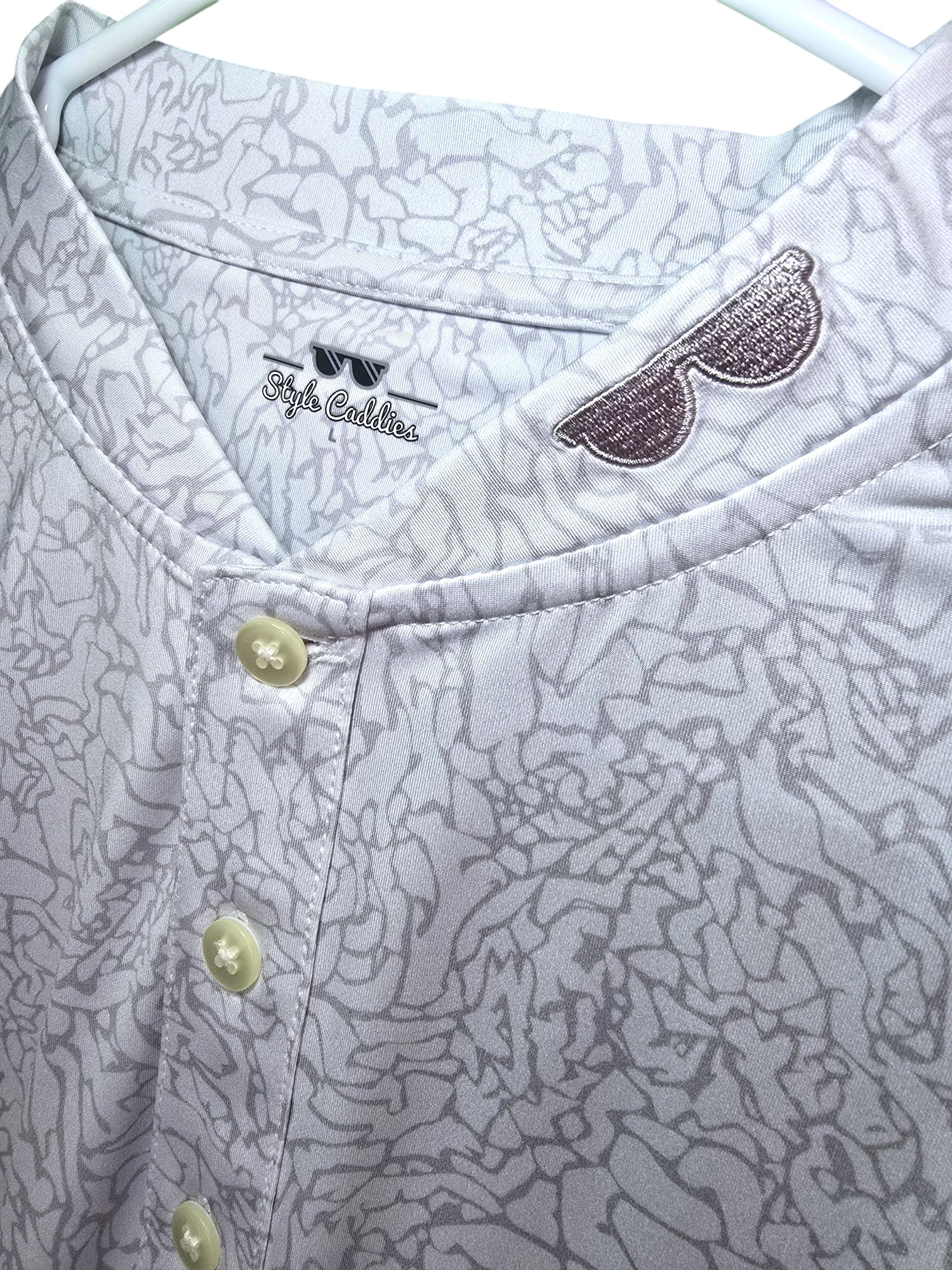 Light cement collarless golf shirt on course