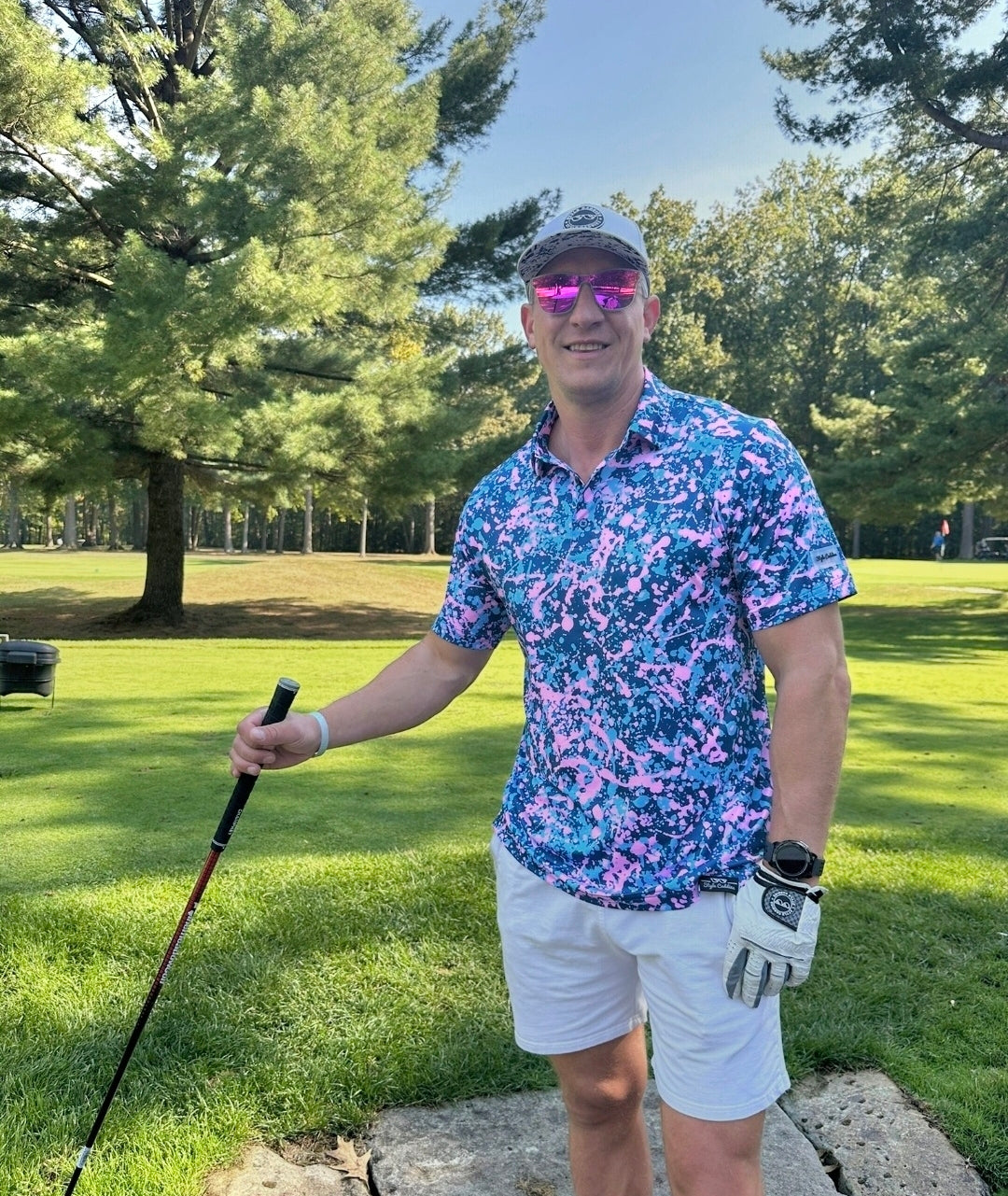 Pinkulator pink blue golf shirt on course
