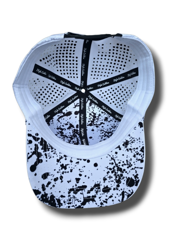 white golf hat with black splatter underneath